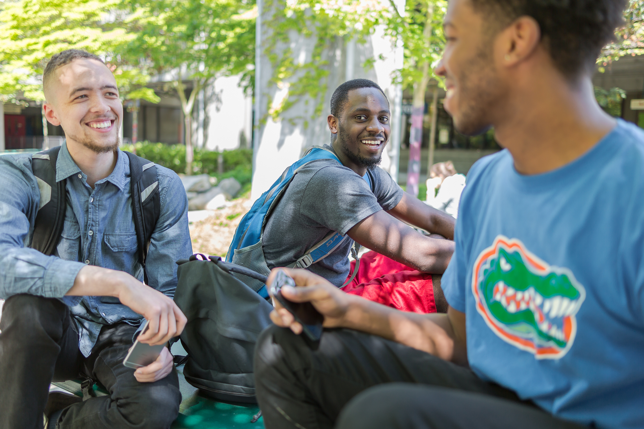 male students smiling with trees in background