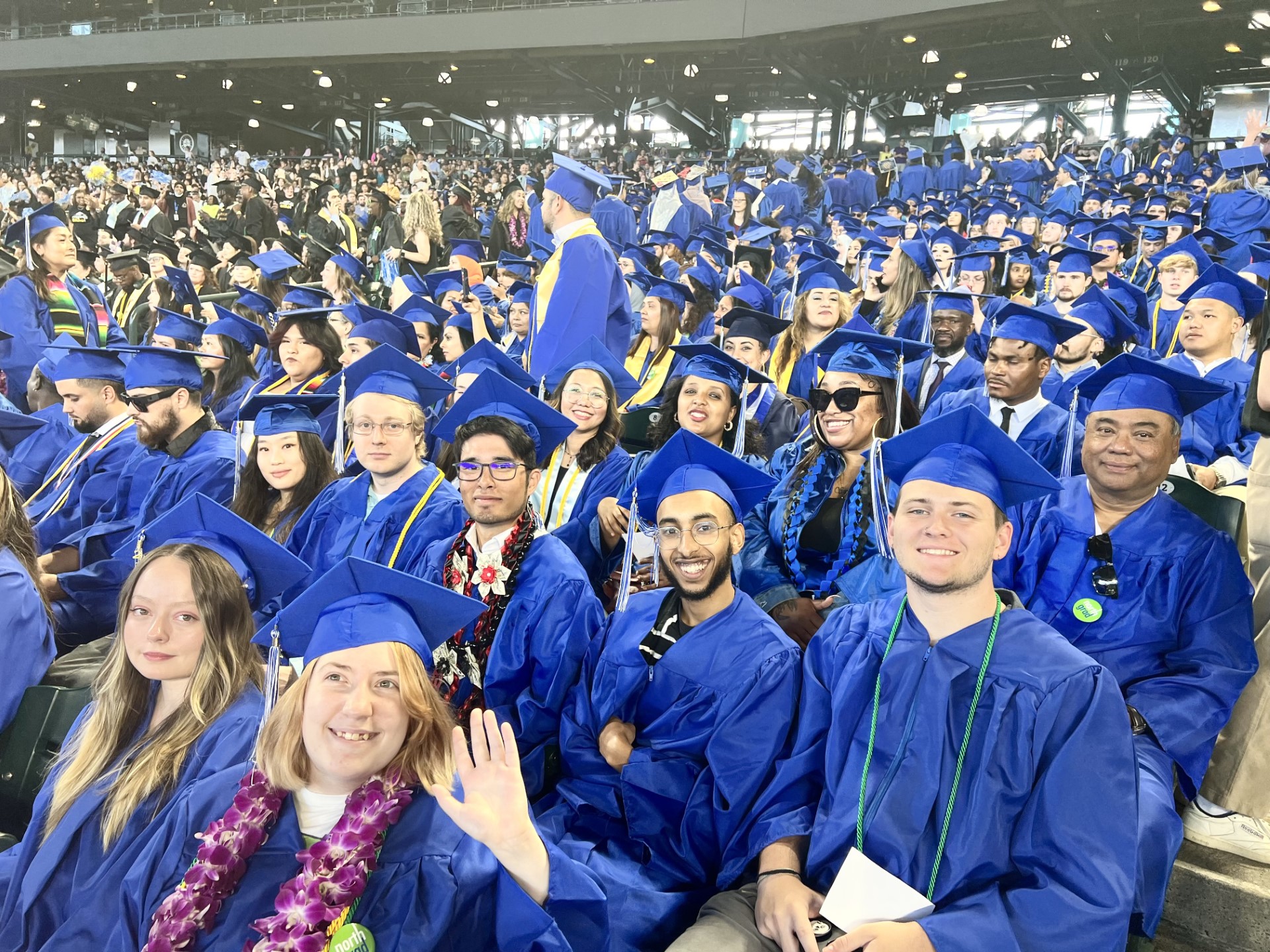 North Seattle College graduates in blue caps and gowns