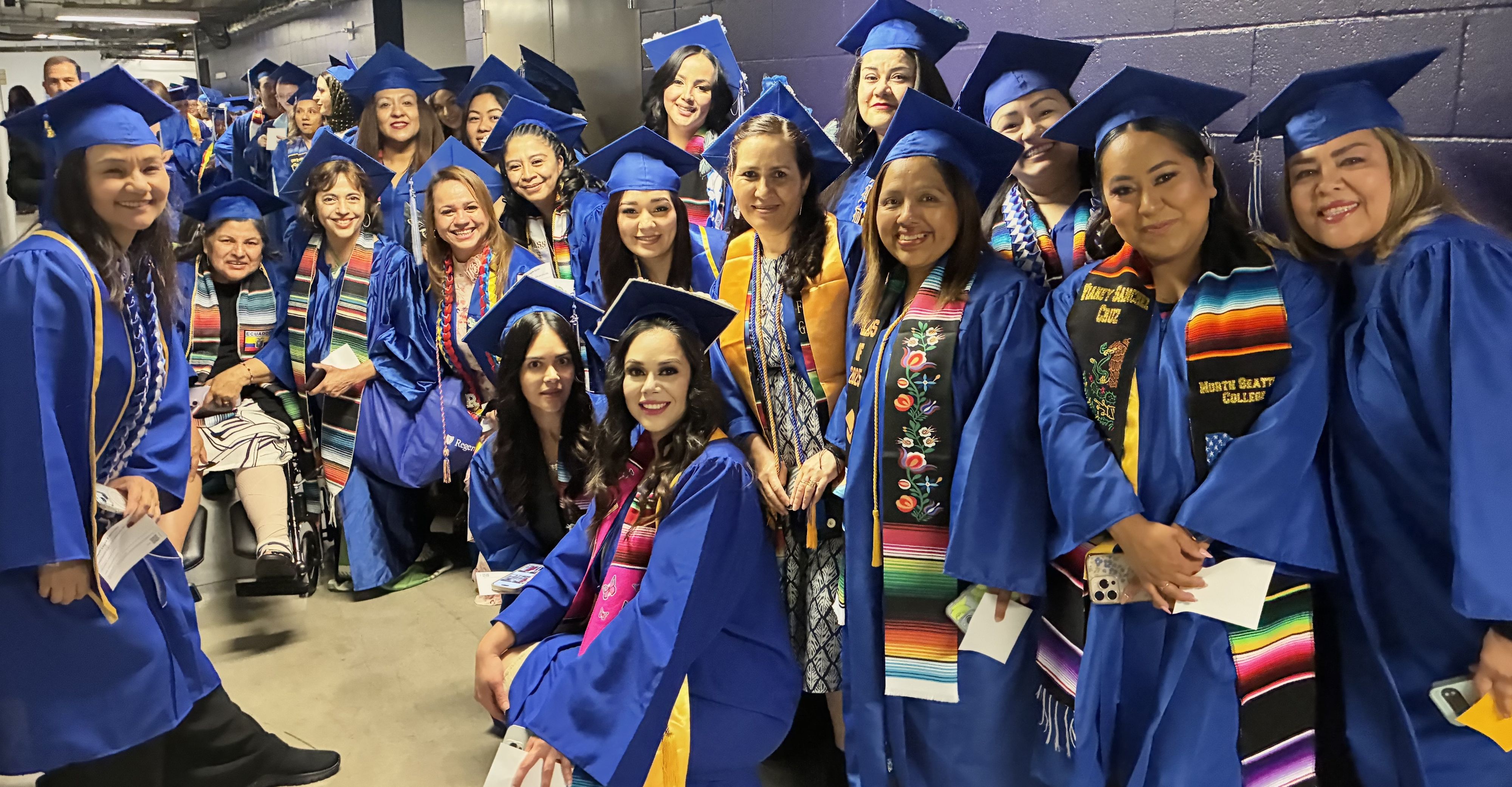 North Seattle College female students wearing blue caps and gowns 