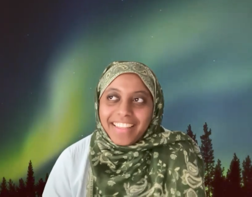 female smiling wearing green head wrap 