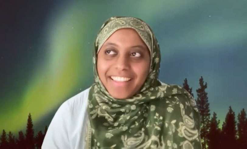 female smiling wearing green head wrap