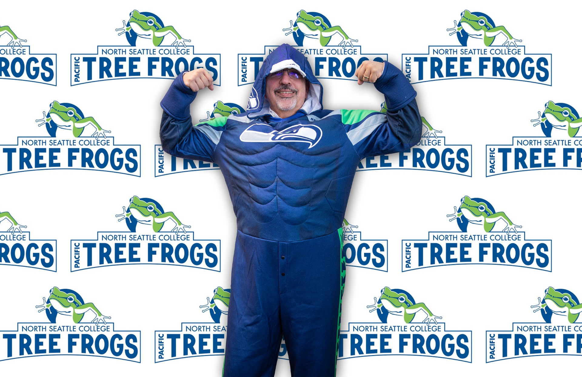 male wearing a blue costume with North Seattle College background 